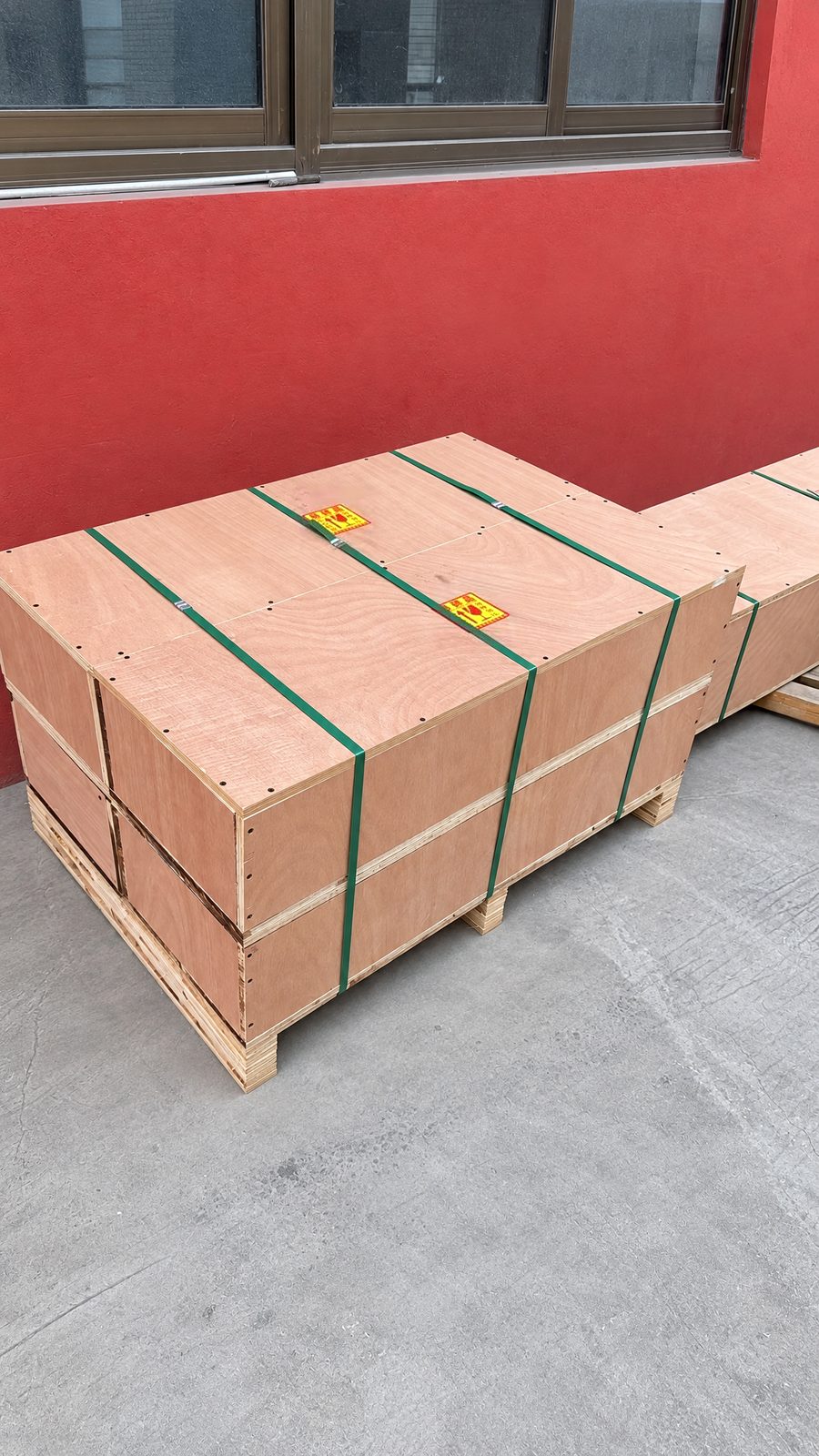 Wooden export crates, strapped and stacked on a pallet, ready for shipment.